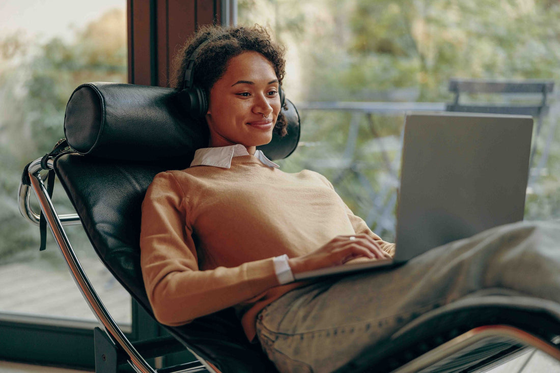 A relaxed person using a laptop at home