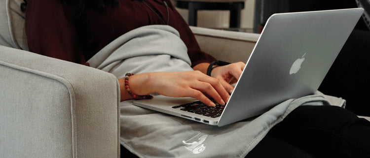 A relaxed person using a laptop at home