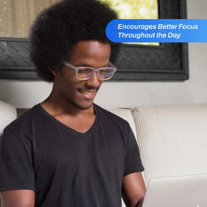 Man wearing Signature Blue Light Glasses sitting on a couch with text about better focus throughout the day.