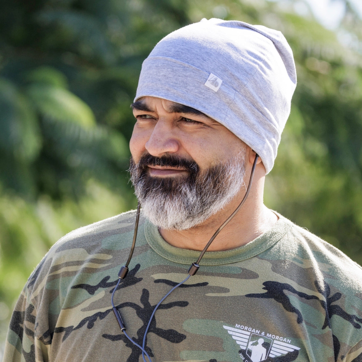 DefenderShield EMF Protection Adult Beanie Gray man outside wearing beanie and earbuds