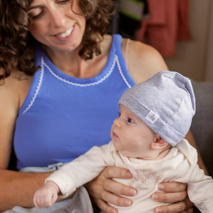 DefenderShield EMF Protection Baby Beanie Gray woman holding baby wearing beanie