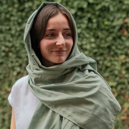 DefenderShield EMF Protection Sage Green Scarf woman smiling outside wearing scarf on head