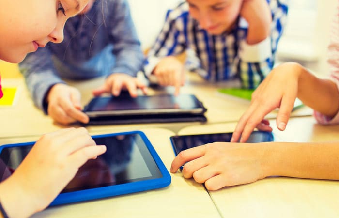 Children using iPads in school